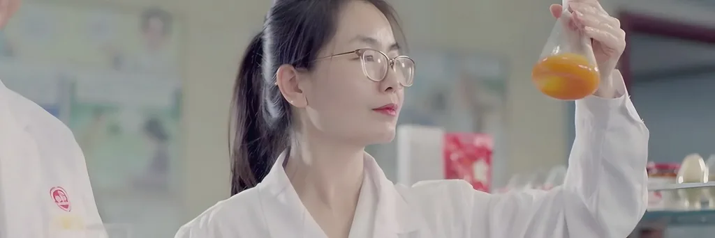A technician checking goji juice in the lab